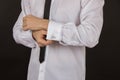 young man in a white shirt with a black tie and expensive c