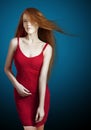 young red hair woman in a red dress Royalty Free Stock Photo