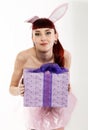 young redhead woman in a bunny suit with gifts Royalty Free Stock Photo