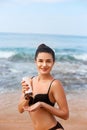 Sexy Young Woman in Bikini Holding Bottles of Sunscreen in Her Hands. Skincare. Royalty Free Stock Photo