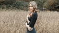 young woman in a black shirt standing in a corn field. Royalty Free Stock Photo