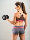 young woman doing dumbbell curl