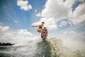 young woman having fun wakesurfing anf jumping on the board Royalty Free Stock Photo