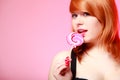 young woman holding candy. Redhair girl eating sweet lollipop Royalty Free Stock Photo