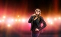 young woman in leather jacket surrounded by care and camera flash. Celebrity, model, star. Royalty Free Stock Photo