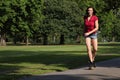 young woman roller skating in park sunshine