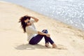 young woman sitting on a beach outdoor fashion portrait Royalty Free Stock Photo