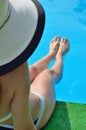 young woman sitting on the ledge of the pool, beautiful fig Royalty Free Stock Photo