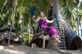 young woman sitting on the swing on the tropical beach, paradise island Bali, Indonesia. Sunny day, happy vacation Royalty Free Stock Photo