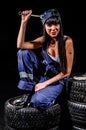 young woman sitting on a tires