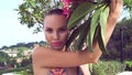 young woman wearing bikini with wet hair and tree flower on a sunny day Royalty Free Stock Photo