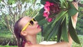 young woman wearing bikini with wet hair and tree flower on a sunny day Royalty Free Stock Photo