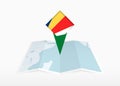Seychelles is depicted on a folded paper map and pinned location marker with flag of Seychelles