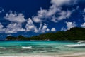 Seychelles Mahe Island - Baie Lazare beach, palm trees and surfers. Royalty Free Stock Photo