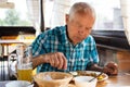 SeÃÂ±or dines on the terrace restaurant in the afternoon Royalty Free Stock Photo