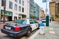 SFPD patrol vehicle beside white and blue fire hydrant on touristy Union Square street, San Francisco, CA