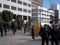 SFPD Police officers stand on street as protesters hold sign say