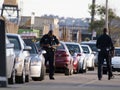 SFPD Police officers write parking tickets along street