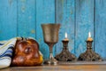 Shabbat candles in glass candlesticks Blurred challah bread