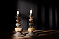 Shabbat candlesticks with burning candles on the kitchen table. Traditional Jewish Shabbat ritual. Shabbat Shalom