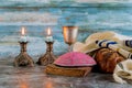 Shabbat challah bread, shabbat wine and candles on the table. Top view