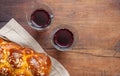Challah bread with two glasses of red wine on wooden table, copy space Royalty Free Stock Photo
