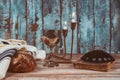 Shabbat eve table candles and cup of wine with covered challah bread