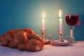 shabbat image. challah bread, shabbat wine and candelas