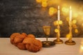 shabbat image. challah bread, shabbat wine and candles on the table