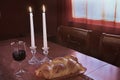 Shabbat Observance At Sunset: Challah, Glass of Wine, Two Lit Candles Royalty Free Stock Photo