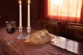 Shabbat Observance At Sunset: Challah, Glass of Wine, Two Lit Candles Royalty Free Stock Photo