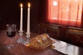 Shabbat Observance At Sunset: Challah, Glass of Wine, Two Lit Candles