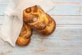 Shabbat Shalom - challah bread on blue wooden background. Top view