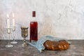 Shabbat Shalom - challah bread, shabbat wine and candles on grey background. Side view. With copy space Royalty Free Stock Photo