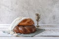 Shabbat Shalom - challah bread, shabbat wine and candles on light grey background Royalty Free Stock Photo