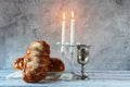 Shabbat Shalom - challah bread, shabbat wine and candles on wooden table Royalty Free Stock Photo