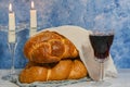 Shabbat Shalom - challah bread, shabbat wine and candles on wooden table