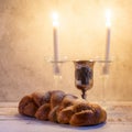 Shabbat Shalom - challah bread, shabbat wine and candles on wooden table Royalty Free Stock Photo