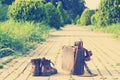 Ankle boots, cardboard suitcase, film camera, brick road. Post-processed.