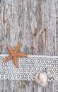 Shabby chic background with seashells and lace on old wood