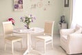 Shabby chic dining room interior with flowers decorative plates Royalty Free Stock Photo