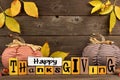 Shabby chic Happy Thanksgiving wood sign with pumpkin decor against wood Royalty Free Stock Photo