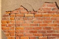 Shabby chic old red clay brick wall with peeling stucco plaster overcoat Royalty Free Stock Photo