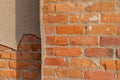 Shabby chic old red clay brick wall with peeling stucco plaster overcoat Royalty Free Stock Photo