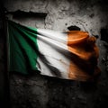 Shabby dirty Irish flag on the background of an old concrete wall