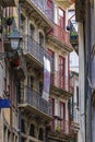 Shabby facades of Portuguese houses and balconies with metal railings in the narrow streets of old town Porto, Portugal Royalty Free Stock Photo