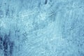 Shabby old fence covered faded blue paint with white smudges on stucco, grunge texture of cold winter hoarfrost. Royalty Free Stock Photo