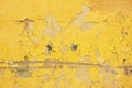 Old wall with bright yellow paint and cracks Royalty Free Stock Photo