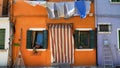 Shabby orange house on Burano island in Venice, summer tourism, poverty concept Royalty Free Stock Photo