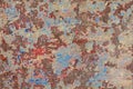 shabby peeled white, blue and red paint layers on concrete surface - flat background and texture Royalty Free Stock Photo